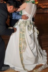 A bride covered in cash during the wedding money dance.